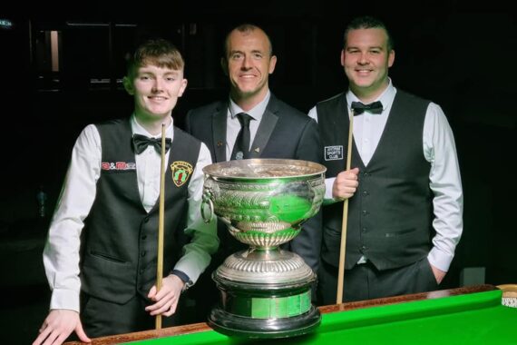 The finalists and the referee pose in front of the table and the Northern Ireland Championship trophy.