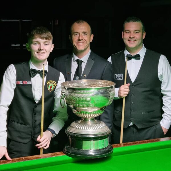 The finalists and the referee pose in front of the table and the Northern Ireland Championship trophy.