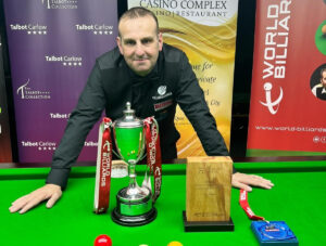 David Causier posing with the World Matchplay Championship trophy after winning it in 2022.