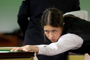 Lilly Meldrum plays a shot at the table.