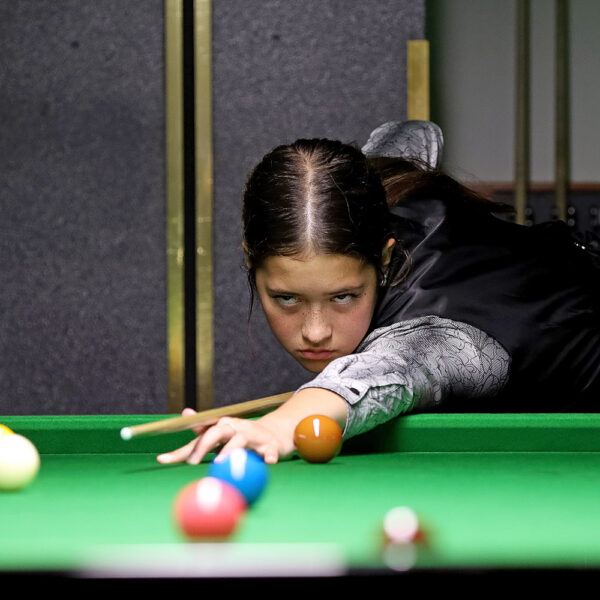 Lilly Meldrum plays a shot at the table.