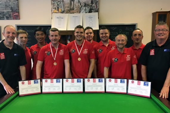 Photo of Chris Lovell with coaches and certificates