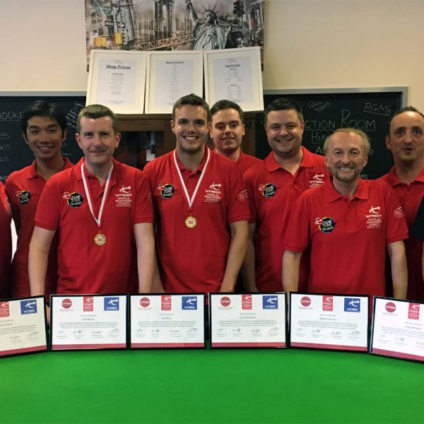 Photo of Chris Lovell with coaches and certificates