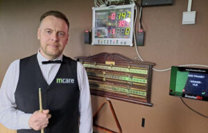 Robin Hull stands by the electronic scoreboard that has his 147 break recorded on it.